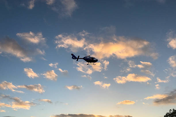 istock A helicopter against a clear sky with clouds. 2210917657