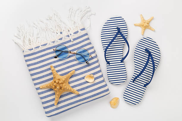 istock Beach towel with summer accessories on color background, top view 2210917832