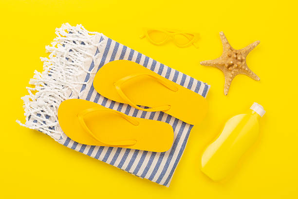 istock Beach towel with summer accessories on color background, top view 2210917834