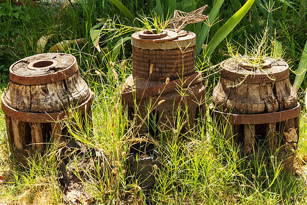 Weathered Wooden Machinery Pieces in Grass