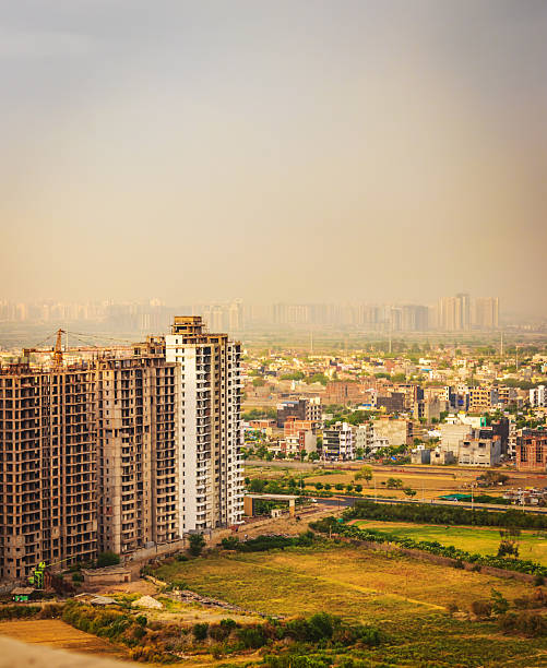 A striking urban scene showcasing modern high-rise residential towers set against a dramatic, moody sky in Noida, India. This dynamic composition captures the essence of rapid urban development, city life, and architectural growth in one of India’s fastest-growing metropolitan regions