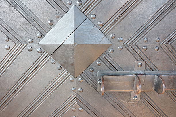 A closeup view of a beautifully decorative metallic door that showcases intricate geometric patterns and textures