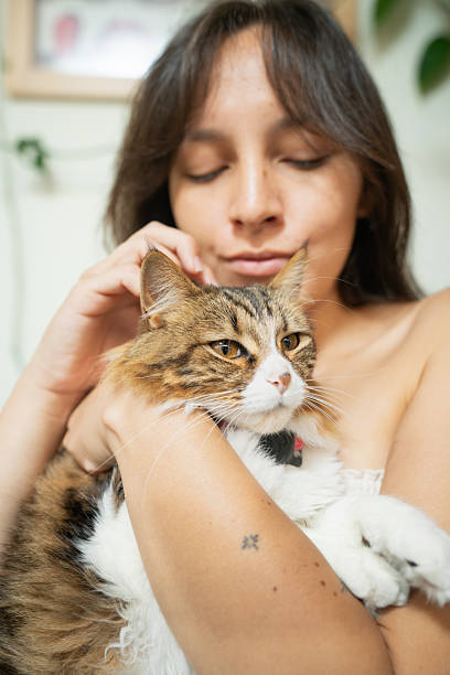 istock Young woman embracing her fluffy cat with closed eyes 2210926701