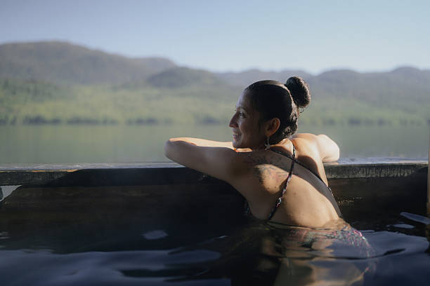 istock Tourist relaxing in hot springs enjoying mountain view 2210927741