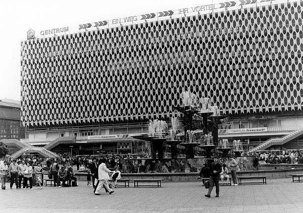 Alexanderplatz in the center of East Berlin with passers-by at the Fountain of the Friendship of Nations in front of the Centrum department store - German Democratic Republik.
