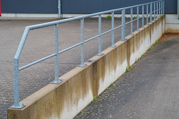 istock Metal railing protecting concrete curb in industrial area 2210939425