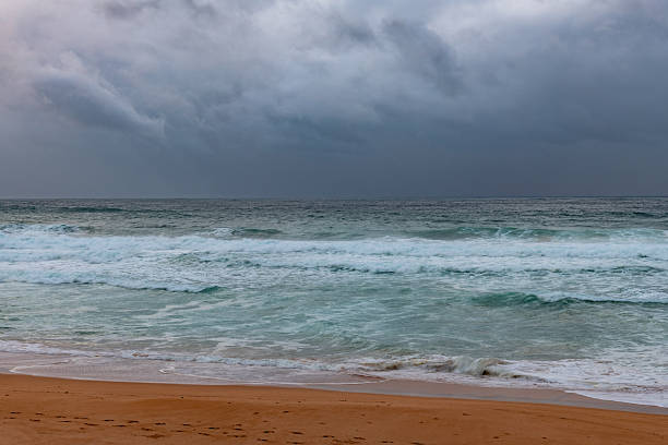istock Moody sunrise with waves at the seaside 2210948620
