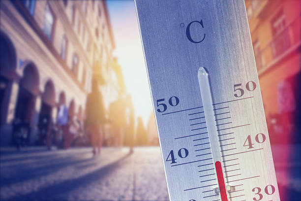 istock A hot summer in a town and a thermometer 2210952231