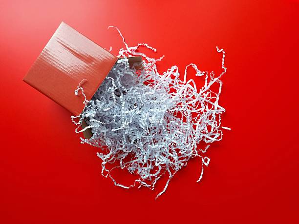 Open red box with white paper filling on red background