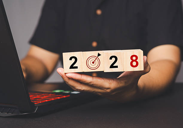 istock Wooden blocks displaying 2028 with a target icon, symbolizing goals and future planning. 2210953297