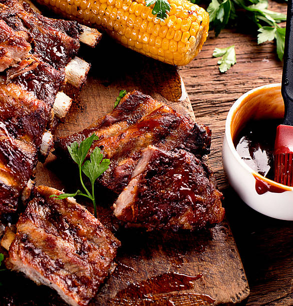 Pork ribs with corn and sauce.