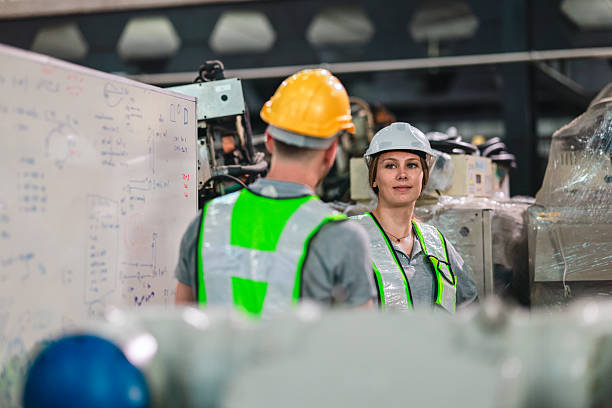 istock Industrial Engineer and Technician Inspecting Robotic Arm Machinery 2210956909