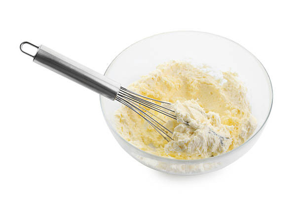 istock Bowl and whisk with delicious cream isolated on white 2210961072