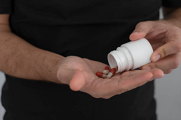 istock Close up of human hands. He is taking pill 2210962111