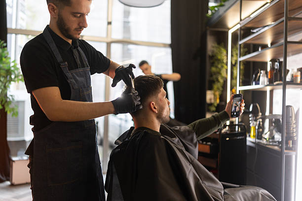 istock Young man having video call during hair cutting 2210963720
