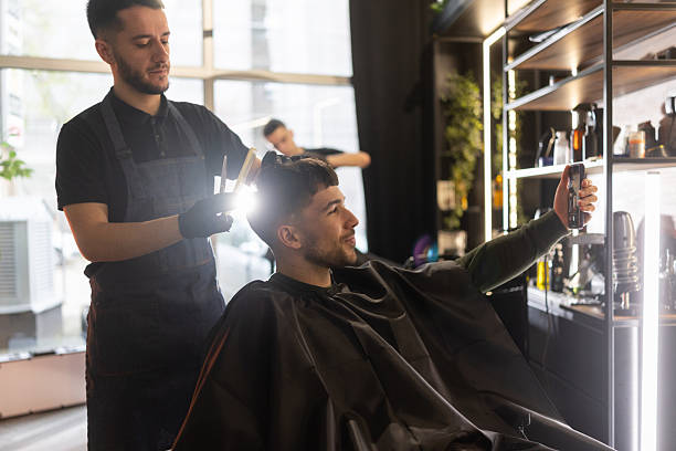 istock Young man having video call during hair cutting 2210963827