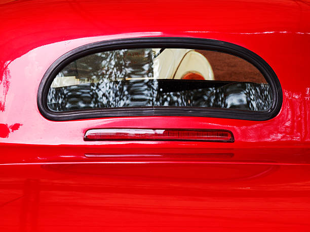 istock Rear window glass on red antique car 2210964128