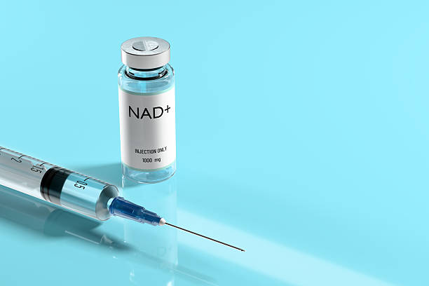 istock NAD. Syringe and vial for injection on blue background. 2210964877