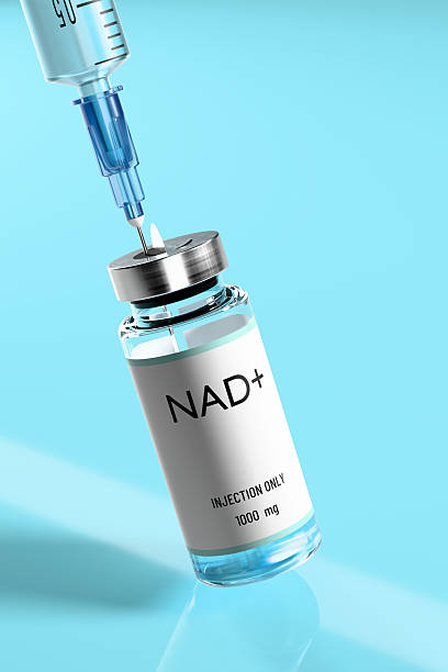 istock NAD solution in vial for injection and syringe close-up on a blue glossy laboratory table. 2210964879