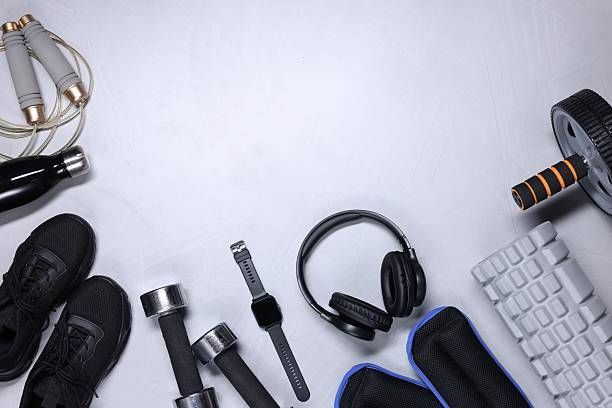 istock Different gym stuff, wrist watch and headphones on light grey textured background, flat lay. Space for text 2210966510