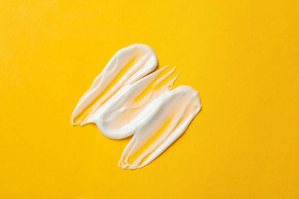 istock Sample of body cream on yellow background, top view 2210966609