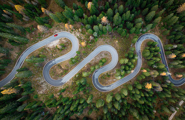 istock Winding road between the greenforest - aerial view 2210968590