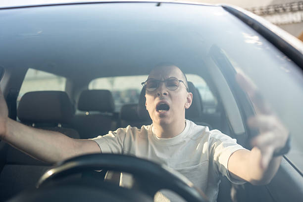 istock Frustrated Driver Reacting Aggressively Inside a Car with Anger 2210969117