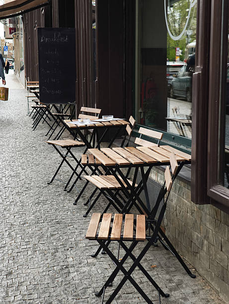 istock Empty tables and chairs standing outside a closed restaurant 2210972609