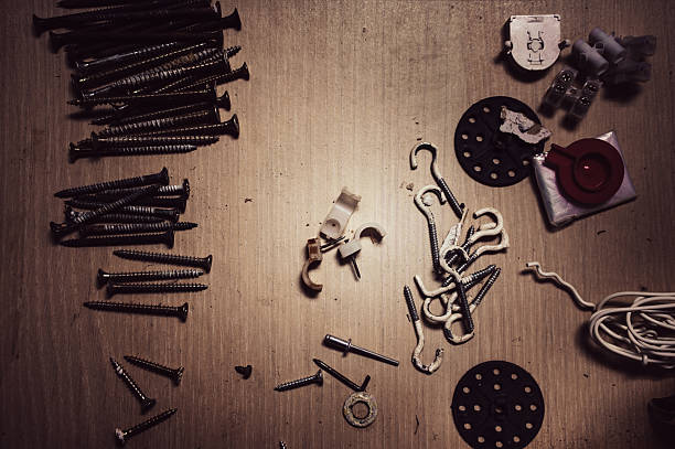 istock Screws and hooks on a wooden table 2210973942