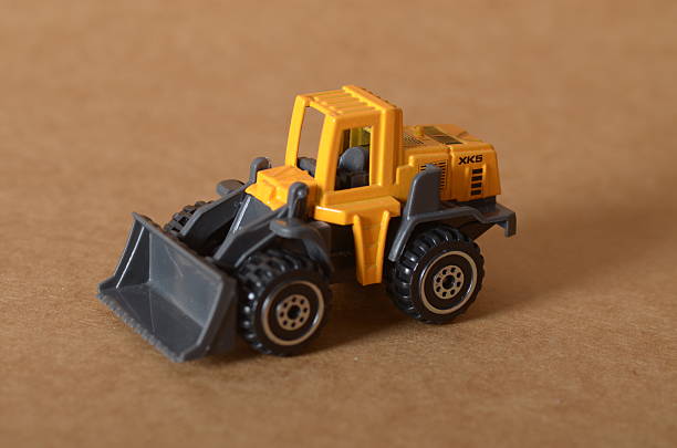 istock Miniature Construction Vehicle with Front Bucket and Treaded Tires 2210977218