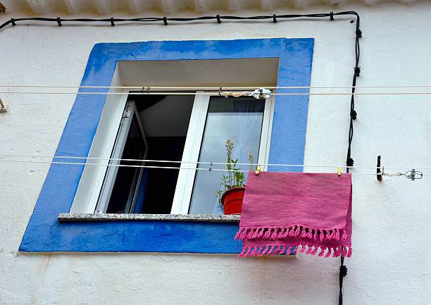 Two broken windows of an old abandoned building with traditional portuguese tiles in porto