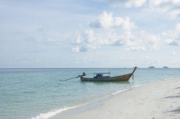 istock A boat is anchored on a quiet beach 2210979203