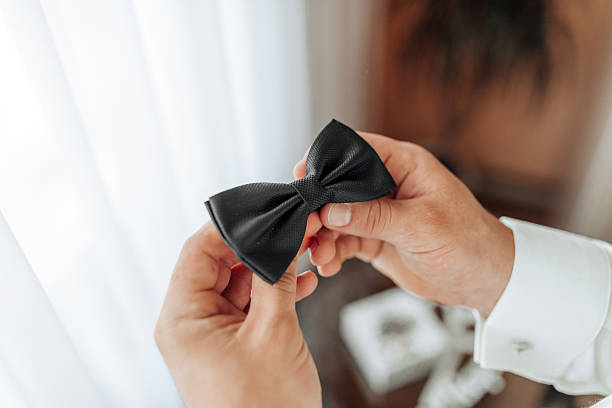 istock A man is holding a black bow tie in his hand 2210980252