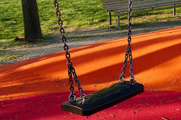 Swing in children playground during sunny day