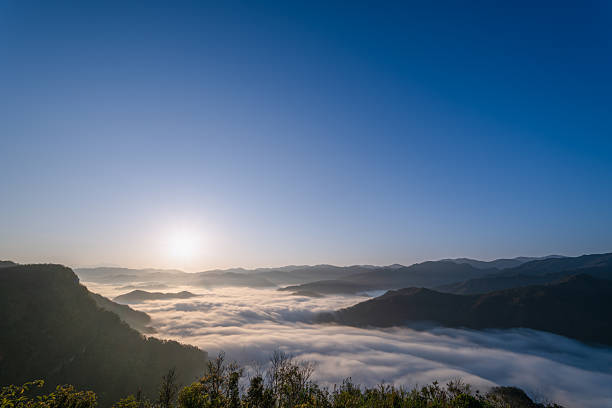 In the quiet hours of dawn, the sun awakens a sea of clouds in Xindian, Taiwan, painting the sky with hues of gold and creating a dreamlike realm.