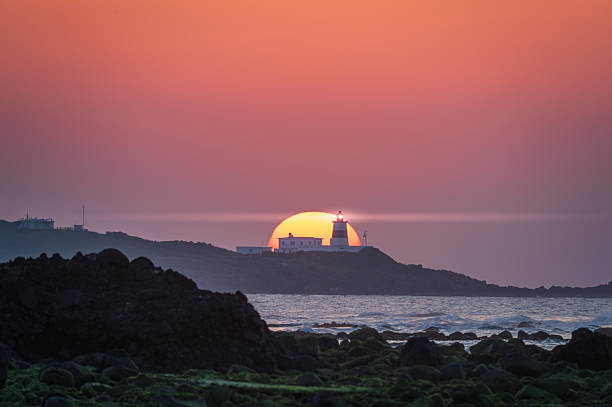 istock Shimen Twilight Symphony: Lighthouse Amid Gentle Ocean Waves. 2210991027