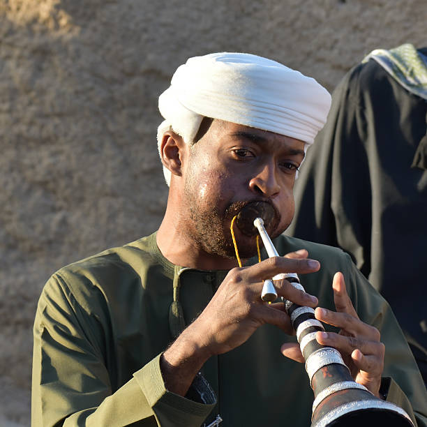 Muscat, Oman - April 01, 2025: Musician with traditional omani ney flute played by a street. Sultanate of Oman