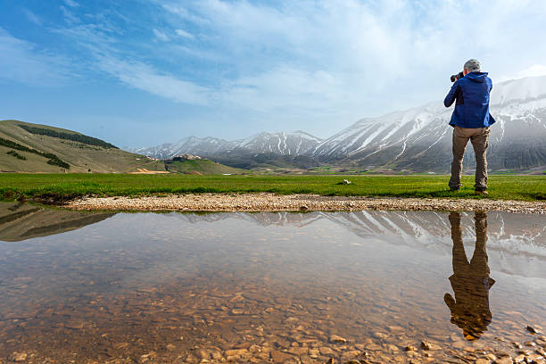 istock Photographer on the water mirror 2210991453