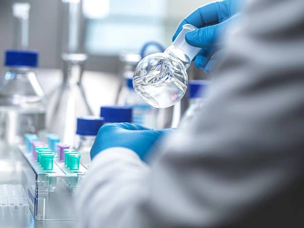 istock A scientist conducts an experiment in a modern laboratory, handling a flask carefully and precisely. 2210994042