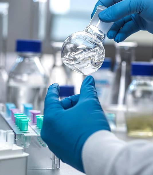 istock Close-up view of a scientist holding a flask with liquid in a lab setting. 2210994086