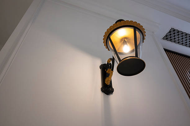 Vintage metal wall lamp on the white wall