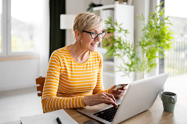 istock Concentrated Senior Woman Handling Finances 2210997009