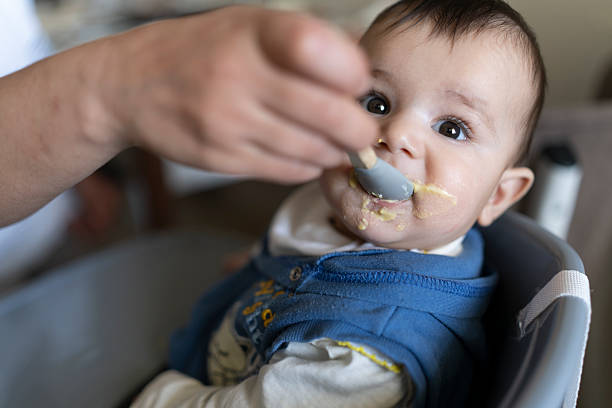 istock A baby eating food. 2210997893