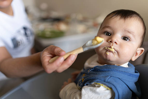 istock A baby eating food. 2210997898