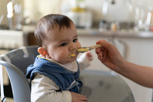 istock A baby eating food. 2210997963