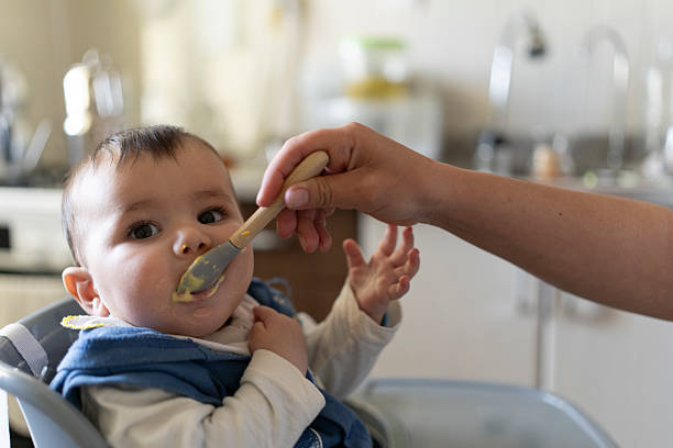 istock A baby eating food. 2210997973