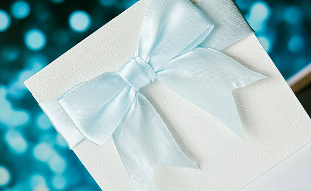 istock White luxury gift box with ribbon bow on soft blue bokeh background perfect for elegant gift presentations 2211004290
