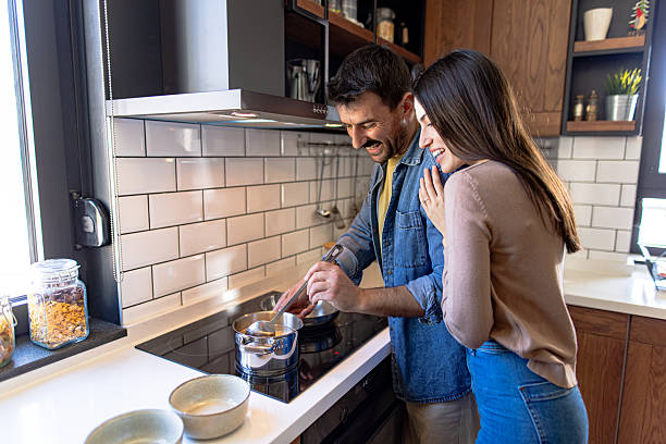 istock Couple Cooking Together in Modern Kitchen 2211004745