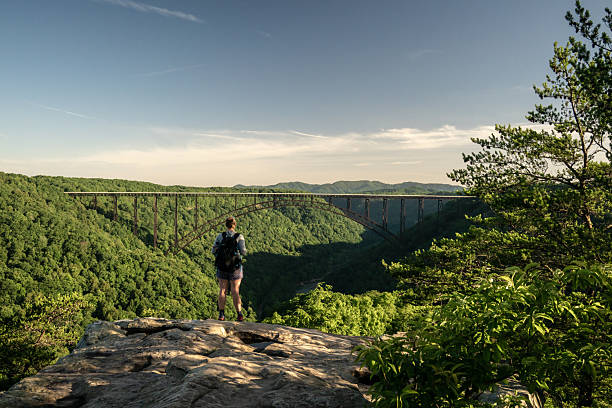 istock Woman Looks out Over New River Bridge 2211005823