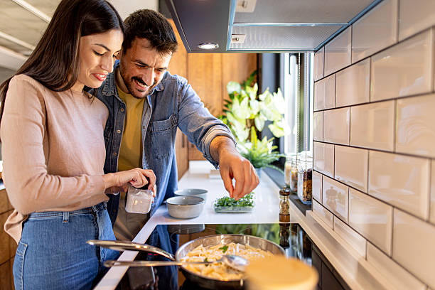 istock Couple Cooking Together in Modern Kitchen 2211006219